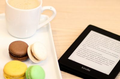 macarons ereader and cup with beverage