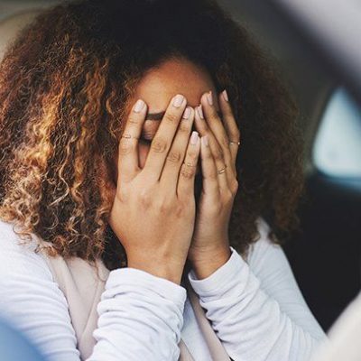 woman in a car having a panic attack